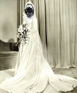 The rear of a mans head shields the face of a bride.